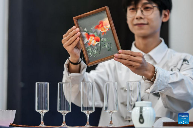 A tea master demonstrates Suzhou embroidery during a Chinese tea cultural event in Budapest, Hungary, on May 19, 2026. [Photo by David Balogh/Xinhua]