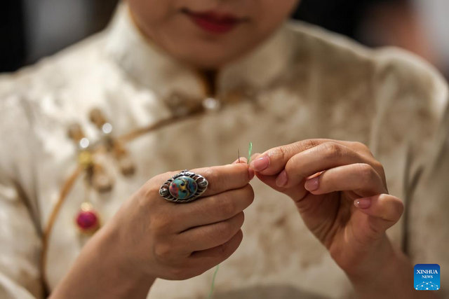 A Chinese artisan demonstrates her embroidery skills during a Chinese tea cultural event in Budapest, Hungary, on May 19, 2026. [Photo by David Balogh/Xinhua]